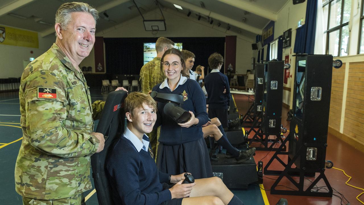 Aviation STEM Motivation Program OIC Major David McEvoy instructs Toowoomba Anglican School students Lachlan Weier and Maleah Roberts in the use of a VR helicopter flight simulator. Picture: Kevin Farmer