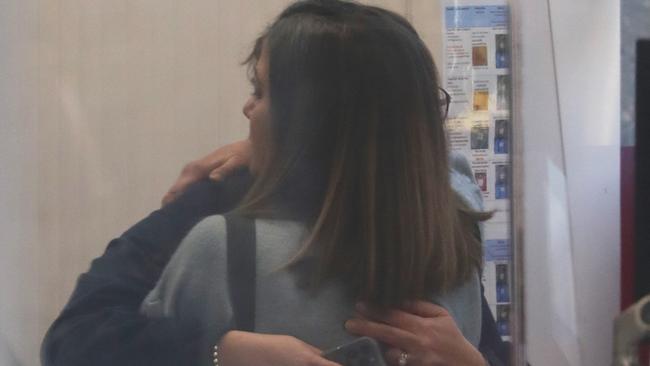 Two people hug outside the service centre. Picture John Grainger