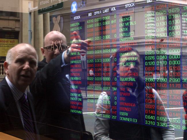 Investors look at stocks on electronic stock boards at the Australia Securities and Exchange (ASX) headquarters in Sydney, Australia, on Tuesday, Sept. 9, 2011. Photographer: Sergio Dionisio/Bloomberg