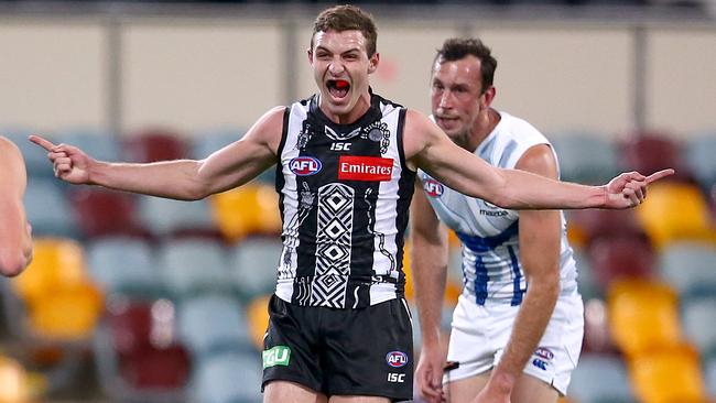 BRISBANE, AUSTRALIA - AUGUST 24: Trey Ruscoe of the Magpies celebrates a goal during the round 13 AFL match between the Collingwood Magpies and the North Melbourne Kangaroos at The Gabba on August 24, 2020 in Brisbane, Australia. (Photo by Jono Searle/AFL Photos/via Getty Images)