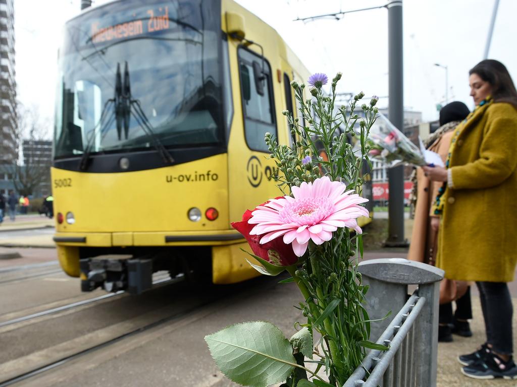 Flowers have been left in tribute to victims at the site of a shooting in a tram. Picture: AFP