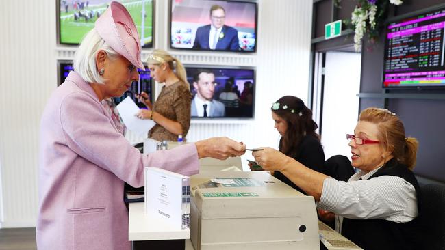 Tabcorp chairman Paula Dwyer places a bet. Picture: Aaron Francis.