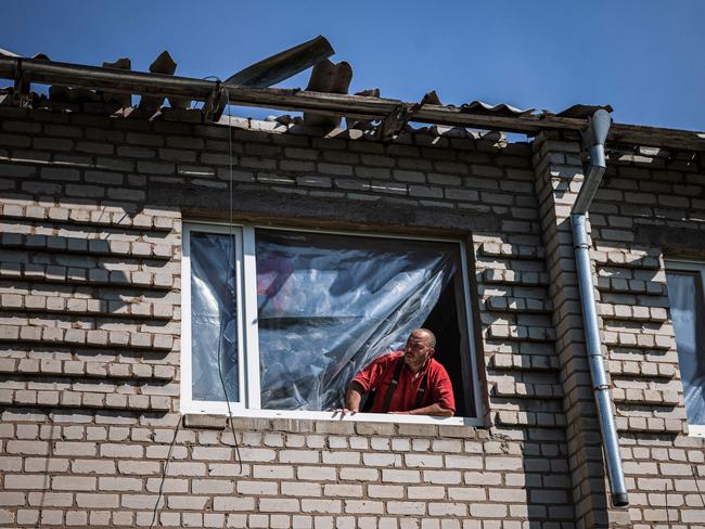 A construction worker looks out of a destroyed window as he fixes damages of a hospital building after shelling by Russian forces in the town of Orikhiv. Picture: AFP