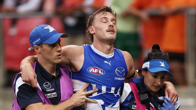 Josh Goater is helped from the field. Picture: Matt King/AFL Photos/via Getty Images )