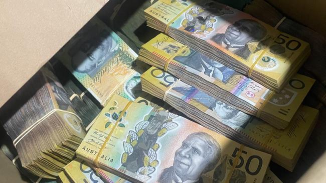 Wads of cash was allegedly found at the properties. Picture: Supplied.