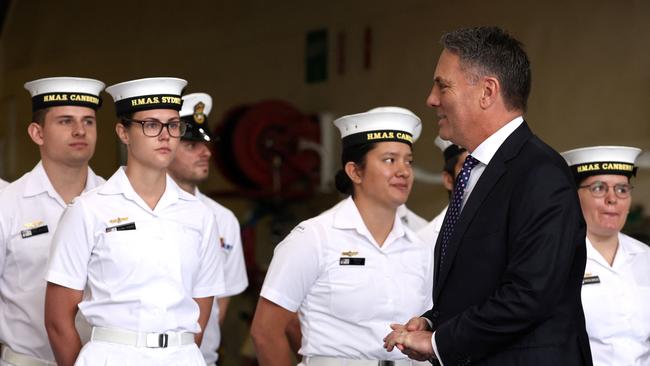 Defence Minister Richard Marles walks past sailors from the Royal Australian Navy aboard the Australian Navy ship HMAS Canberra in Sydney.