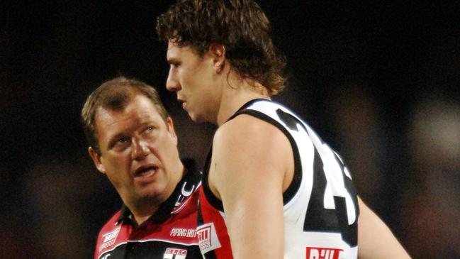 St Kilda coach Grant Thomas talks to injured Saint Justin Koschitzke