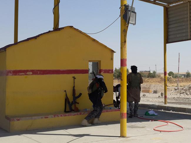 Islamic State group militants and Tribal fighters take control of a checkpoint that belonged to Kurdish Peshmerga fighters. AP Photo