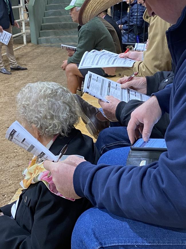 A prospective buyer checks their phone.