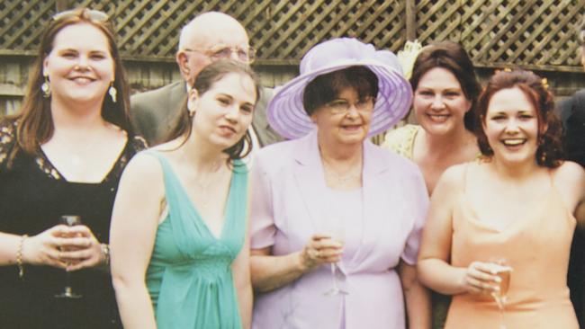 Kirra McLoughlin (in orange) surrounded by family on her wedding day. 