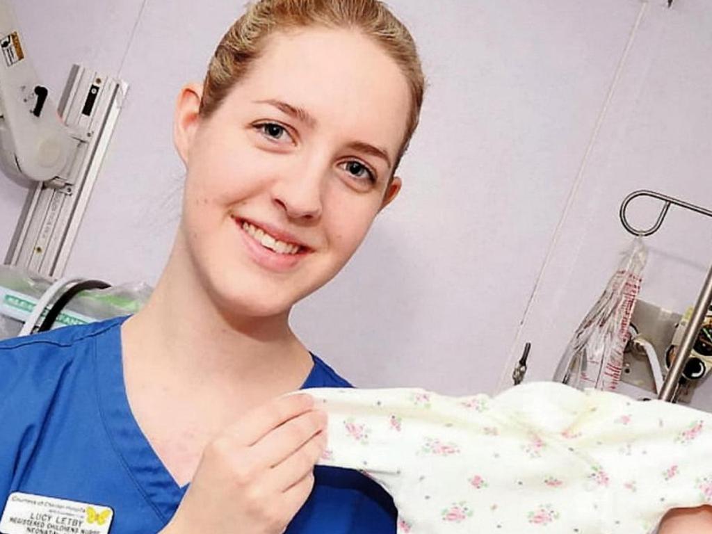 Lucy Letby posed on a ward holding a baby sleepsuit and described her love of the job. Picture: SWNS