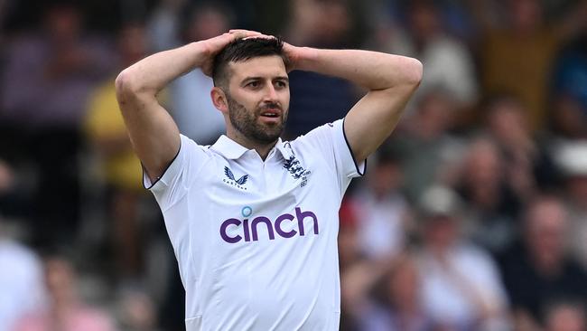 England's Mark Wood reacts to a dropped catch from Jonny Bairstow. Picture: AFP