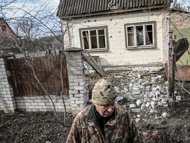 A man stands in front of a destroyed house by shelling in the town of Stoyanka, west of Kyiv. Picture: AFP.