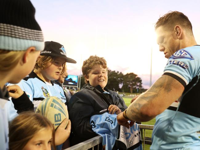 Cameron McInnes signs autographs for the crowd after the Sharks’ round 15 match at Coffs Harbour. Picture: Mark Kolbe/Getty Images