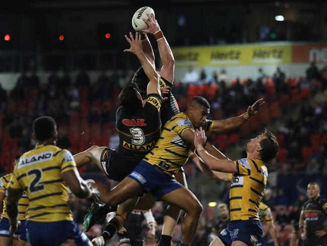 Penrith's Liam Martin flies high to grab a NAthan Cleary kick and score a try for Penrith. Picture: Brett Costello