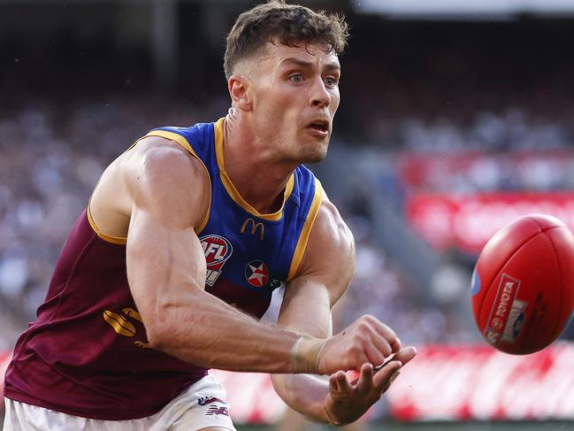 MELBOURNE, AUSTRALIA - SEPTEMBER 30: Josh Dunkley of the Lions handballs during the 2023 AFL Grand Final match between Collingwood Magpies and Brisbane Lions at Melbourne Cricket Ground, on September 30, 2023, in Melbourne, Australia. (Photo by Daniel Pockett/AFL Photos/via Getty Images)