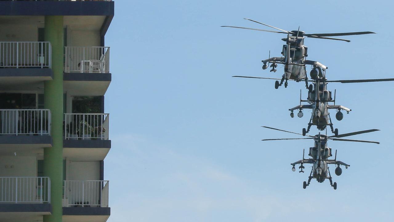 Attack Helicopters conduct a flypast during the march on Darwin's Knuckey St commemorating ANZAC Day 2021. Picture Glenn Campbell