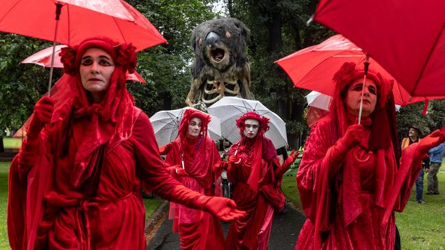 Environmental activists march through Treasury Garden in Melbourne.