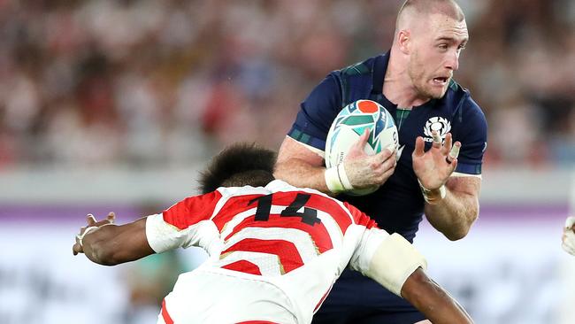 Japan’s Kotaro Matsushima zeroes in on the belly button of Scotland’s Stuart Hogg in a classic tackle on Sunday night. Picture:Cameron Spencer/Getty Images