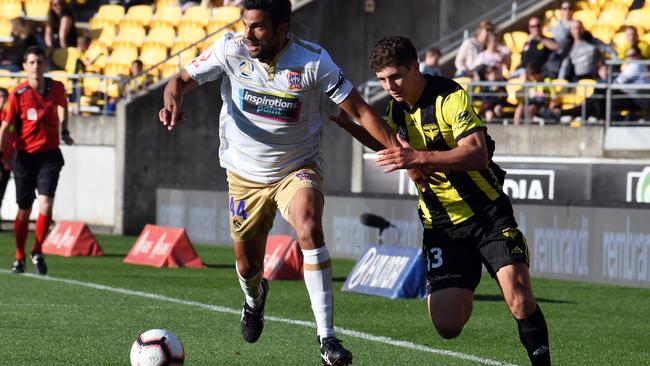 Nikolai Topor-Stanley of the Newcastle Jets and Liberto Cacace of the Phoenix contest the ball in the A-League.