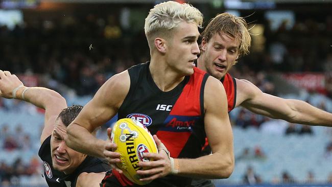 AFL Round 11. 02/06/2019.   Essendon v Carlton at the MCG.   Essendon's Matt Guelfi  gets away from Patrick Cripps of the Blues    . Pic: Michael Klein.