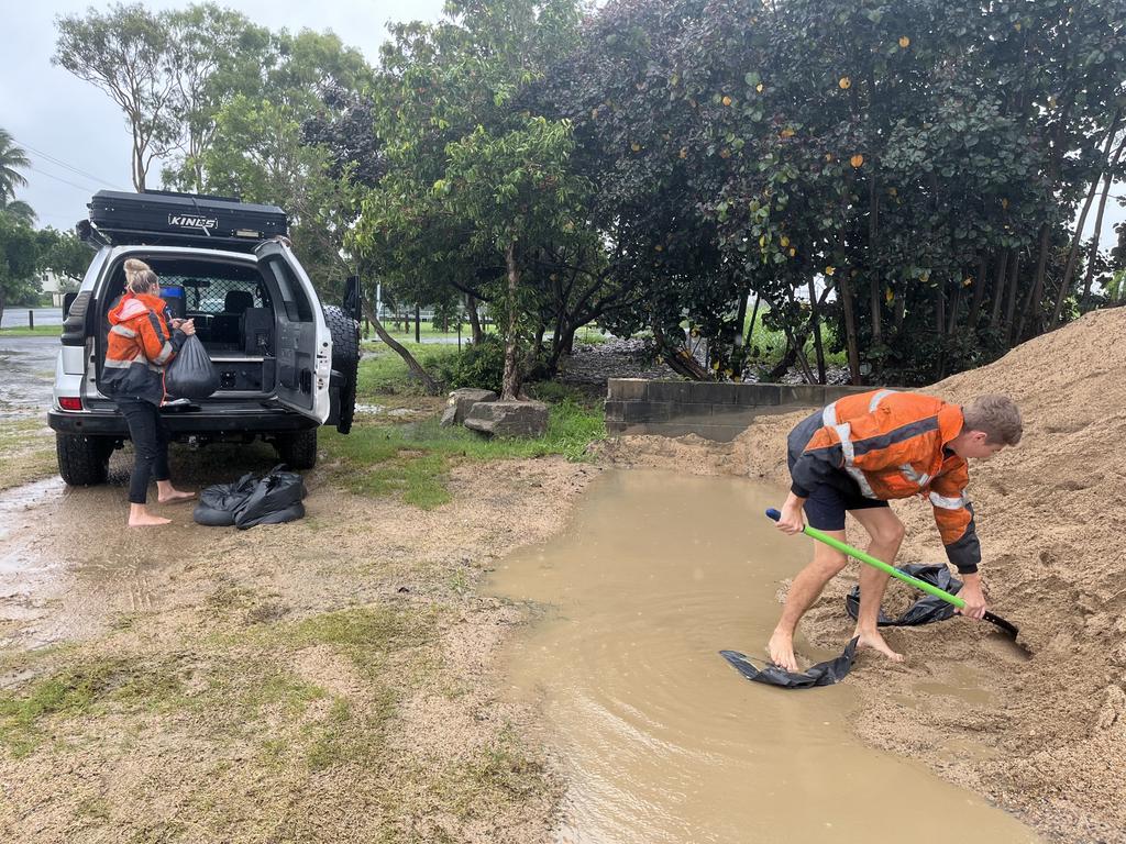 Taylah Forbes and Ben Stubbings are stocking up on sandbags as floodwaters threaten their home. Picture: Luke Lay