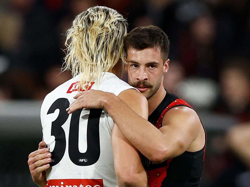 MELBOURNE, AUSTRALIA - APRIL 25: Darcy Moore of the Magpies and Kyle Langford of the Bombers embrace after a draw during the 2024 AFL Round 07 match between the Essendon Bombers and the Collingwood Magpies at the Melbourne Cricket Ground on April 25, 2024 in Melbourne, Australia. (Photo by Michael Willson/AFL Photos via Getty Images)