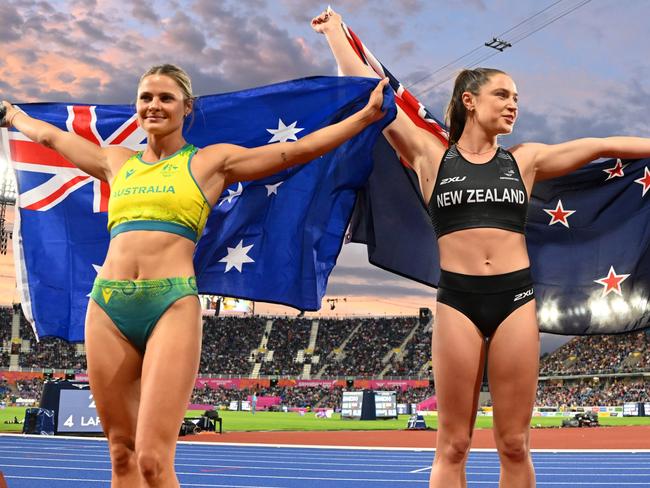 BIRMINGHAM, ENGLAND - AUGUST 02: (L-R) Gold medalist Nina Kennedy of Team Australia, Bronze Medalist Imogen Ayris of Team New Zealand and Silver medalist Sophie Cook of Team England celebrate with their countries flag after the Women's Pole Vault Final on day five of the Birmingham 2022 Commonwealth Games at Alexander Stadium on August 02, 2022 in the Birmingham, England. (Photo by David Ramos/Getty Images)