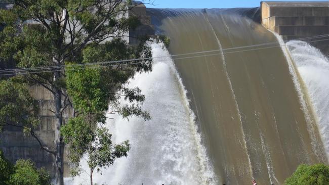 The Hinze Dam spews mass amounts of water after a 900mm deluge. The dam level is 6m above the spillway. Photo: SEQ Water