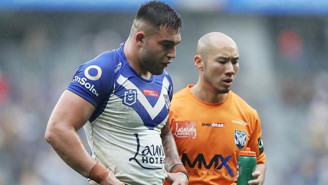 Nick Cotric departs the field for assessment. (Photo by Mark Metcalfe/Getty Images)