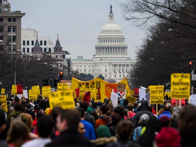 Anti-war activists march from the White House to the Trump International Hotel in Washington on Saturday. Picture: AFP