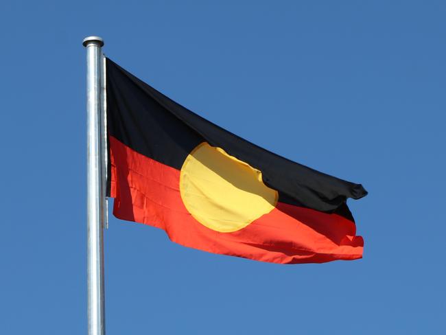 The Aboriginal flag is now flying over the Stuart Highway and Bagot Rd intersection for the first time after the NT Government spent about $220,000 constructing new flag poles.