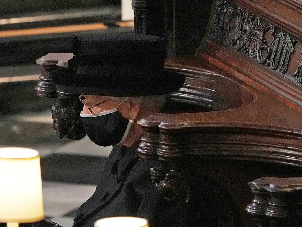 Queen Elizabeth II sits alone in the quire of St George's Chapel during the funeral service of her husband Britain's Prince Philip, Duke of Edinburgh in Windsor Castle. Picture: AFP