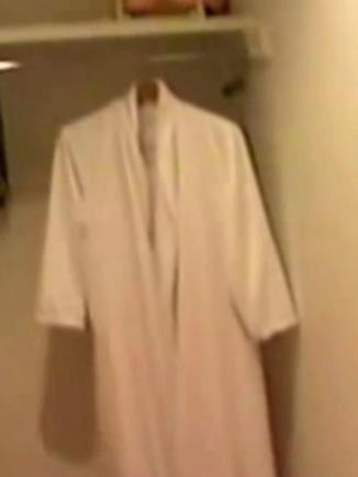 A bathrobe hangs in a wardrobe at Epstein's mansion.