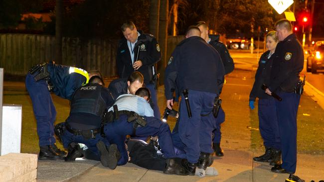 Officers tackle the driver to the ground. Picture: Damian Hofman