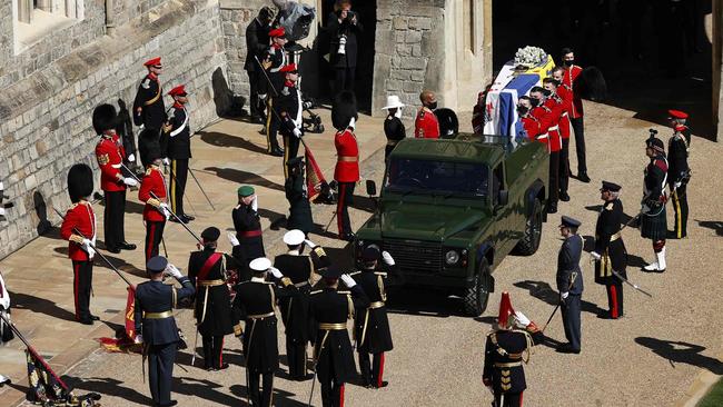 Philip’s coffin is laid onto a modified Land Rover Defender. Picture: AFP.