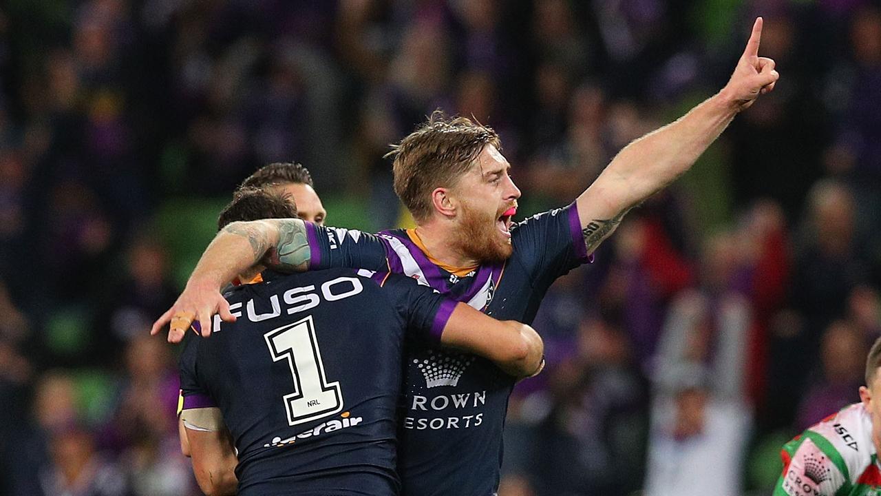 Cameron Munster of the Storm celebrates kicking a field goal against the Rabbitohs.