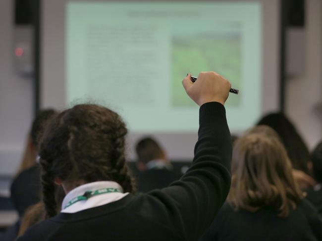 LONDON, ENGLAND - DECEMBER 01:  A student raises her hand in a geography lesson at a secondary school on December 1, 2014 in London, England. Education funding is expected to be an issue in the general election in 2015.  (Photo by Peter Macdiarmid/Getty Images)