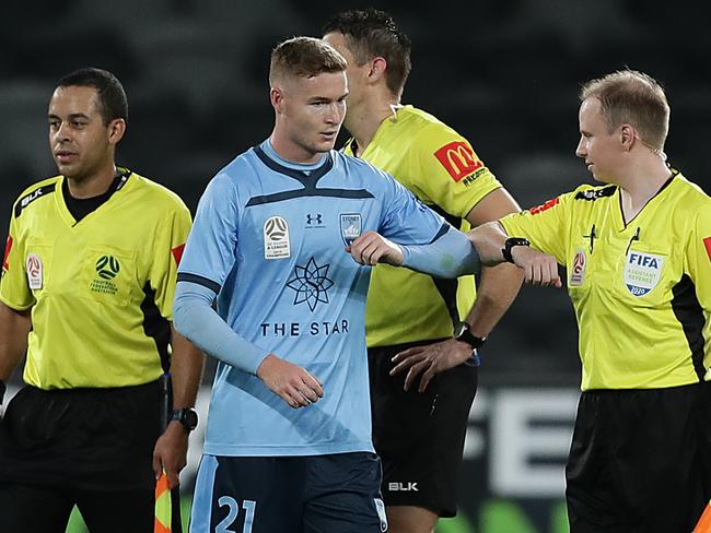 SYDNEY, AUSTRALIA - MARCH 21: Players and officials bump fists and arms after the round 24 A-League match between the Western Sydney Wanderers and Sydney FC at Bankwest Stadium on March 21, 2020 in Sydney, Australia. (Photo by Mark Metcalfe/Getty Images)