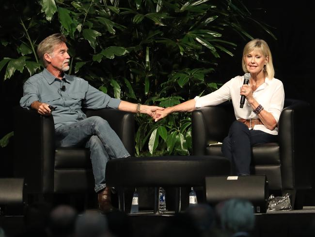 Olivia Newton-John and husband John Easterling talking at cannabis seminar in Portland and showing personal photos to the group as they talk. Picture: Clint Brewer