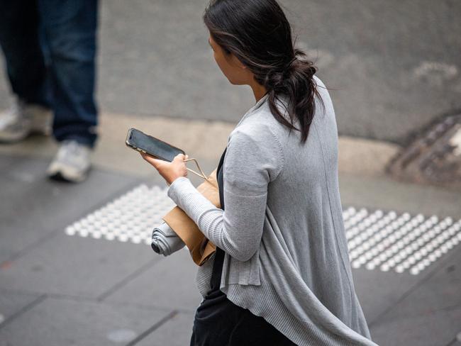 SYDNEY, AUSTRALIA - NewsWire Photos February 06, 2024:  A generic photograph of people on their phone in Sydney.Picture: NCA NewsWire / Christian Gilles