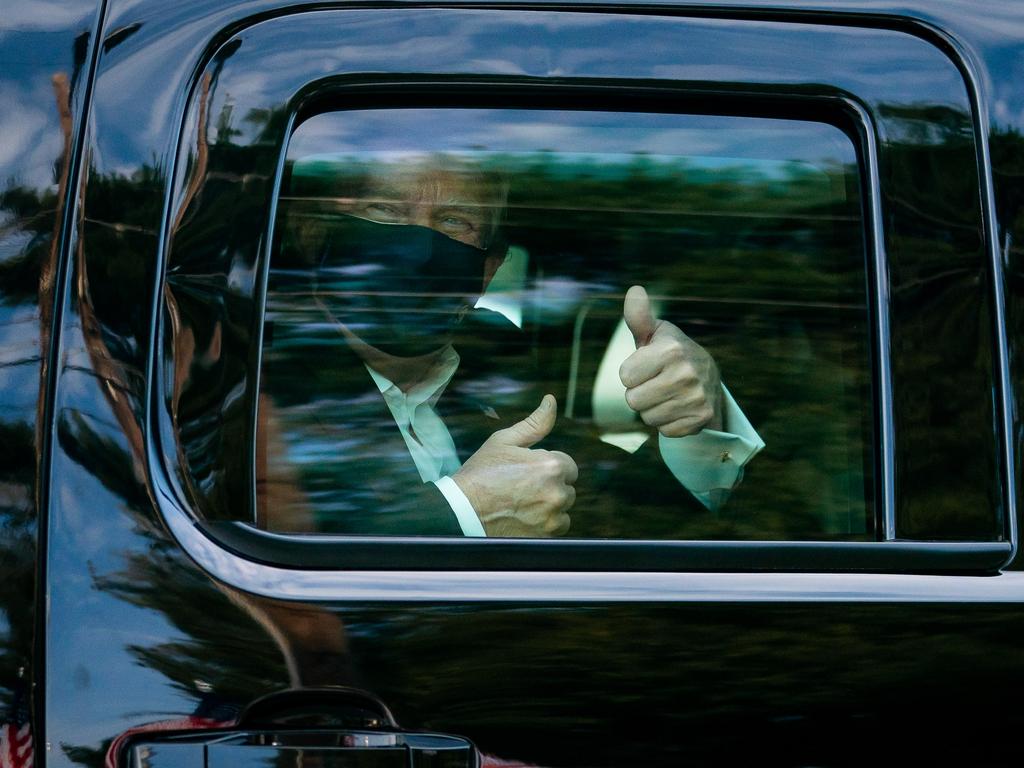 Donald Trump greets supporters during a drive by outside of Walter Reed National Military Medical Centre in October. Picture: Supplied