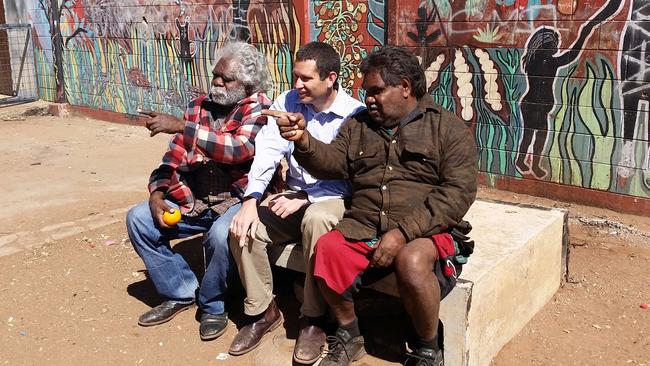 Former APY Lands board chairman Trevor Adamson with Aboriginal Affairs Minister Kyam Maher and Jamie Nyaningu outside the Mai Wiru community store at Pukatja.