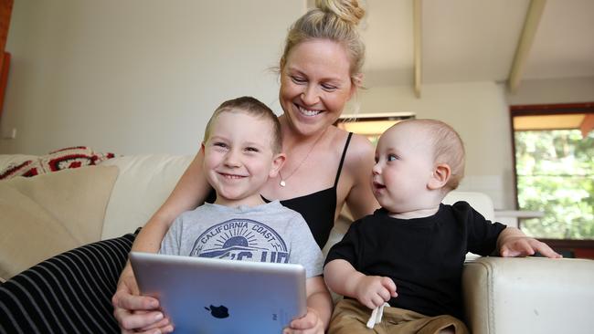 Claire Belford watches what her sons Louis, 4, and Reuben, 1, are watching on the screen. Picture: Tim Hunter.