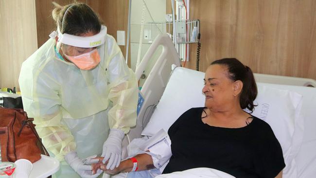 Registered nurse Dawn Medan tends to Covid-positive patient Charmaine Pangi at Mackay Base Hospital. Picture: Contributed