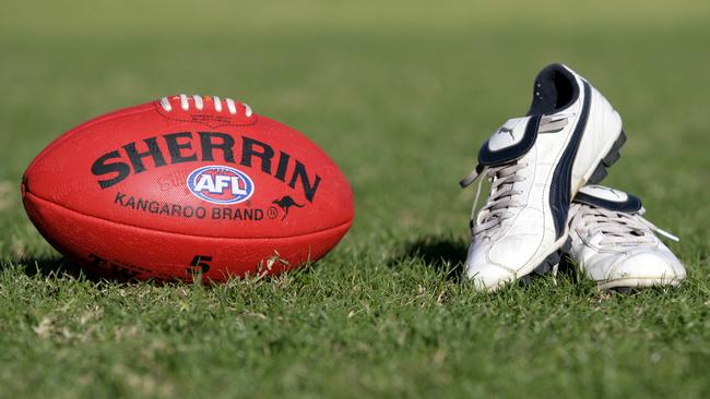 Generic AFL Sherrin football and football boots. sport /