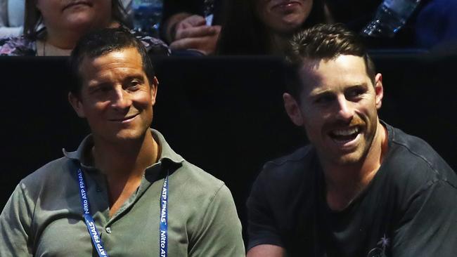 Bear Grylls (L) and Bernard Foley of the Australian Wallabies watch the match between Roger Federer and Marin Cilic.