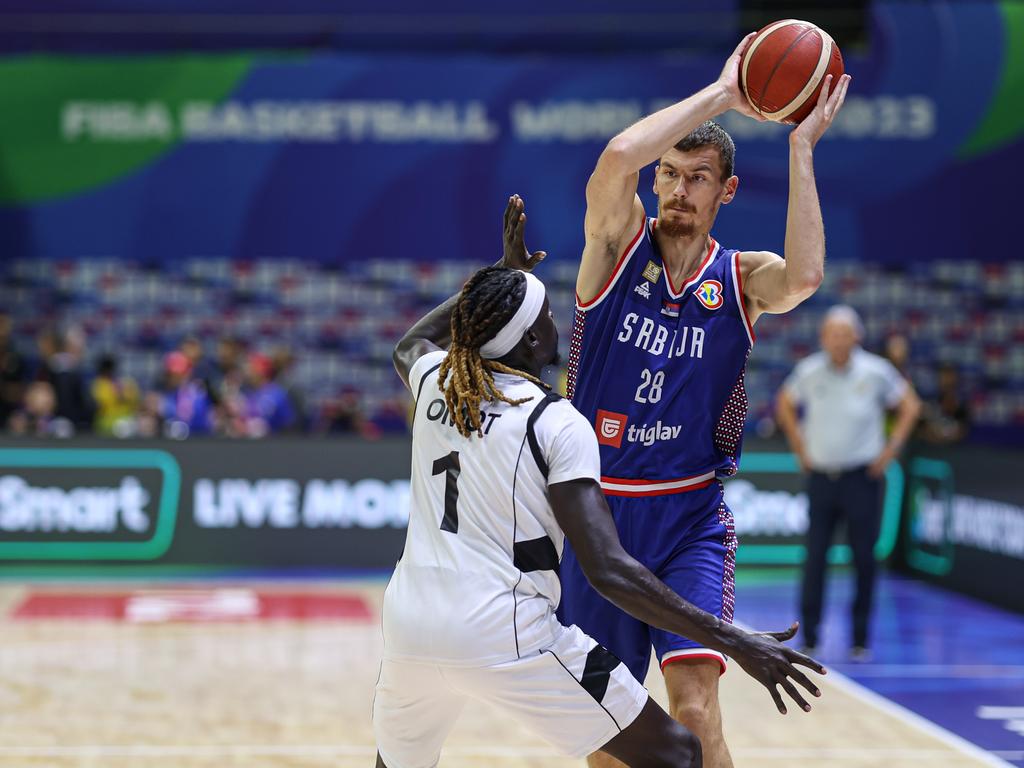 MANILA, PHILIPPINES - AUGUST 30: Borisa Simanic #28 of Serbia drives the ball against Nuni Omot #1 of South Sudan during the first round Group B match between South Sudan and Serbia on day 6 of the FIBA Basketball World Cup at Araneta Coliseum on August 30, 2023 in Manila, Philippines. (Photo by Liu Lu/VCG via Getty Images)