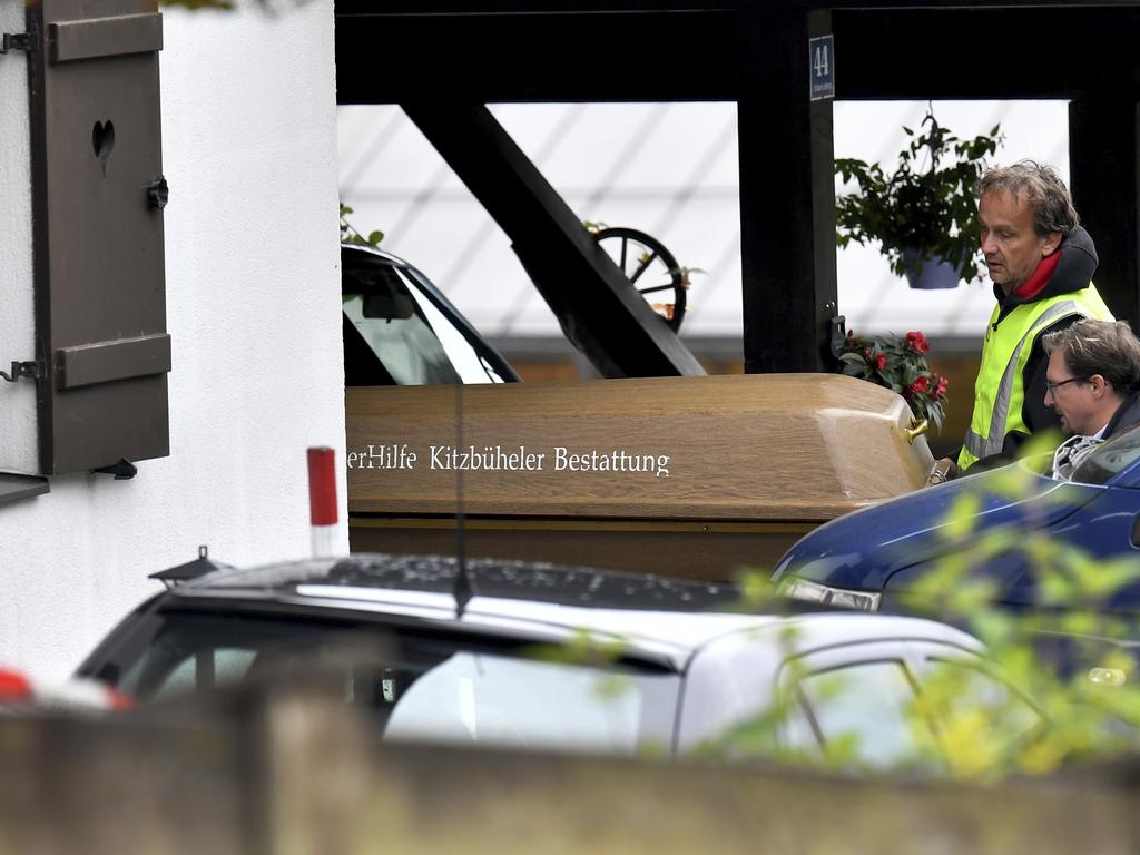 A coffin is carried out of a house in Kitzbuehl, Austria, with a 25-year-old man in custody after allegedly killing his ex-girlfriend, her family, and her new boyfriend. Picture: AP Photo