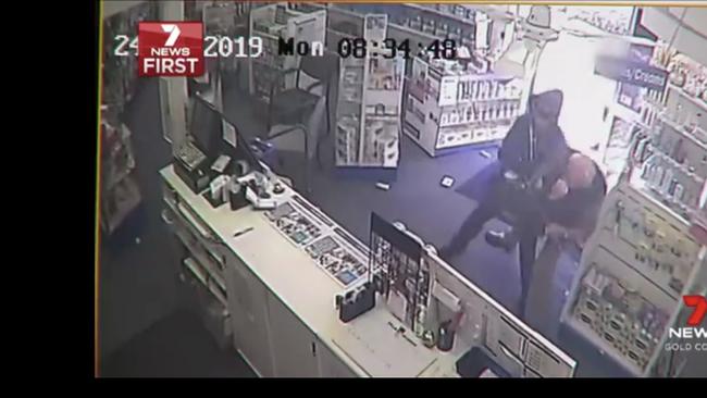 Still from CCTV video of a cleaner bravely confronting raiders at a Nerang pharmacy. Picture: 7News